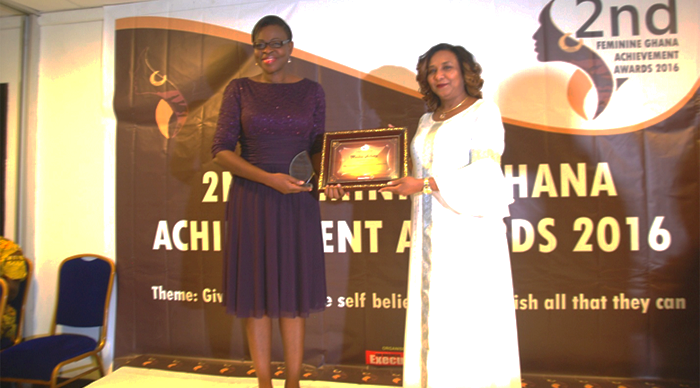 Ms Arkutu (left) receiving a trophy and plaque from Mrs Mona Quartey, a Deputy Minister of Finance.